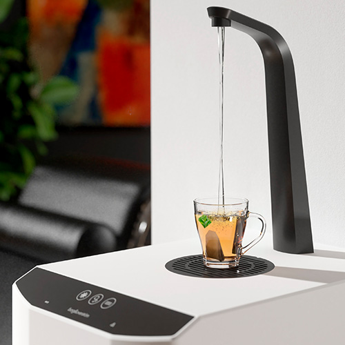 Borg & Overström E7 Water Dispenser dispensing water into a cup