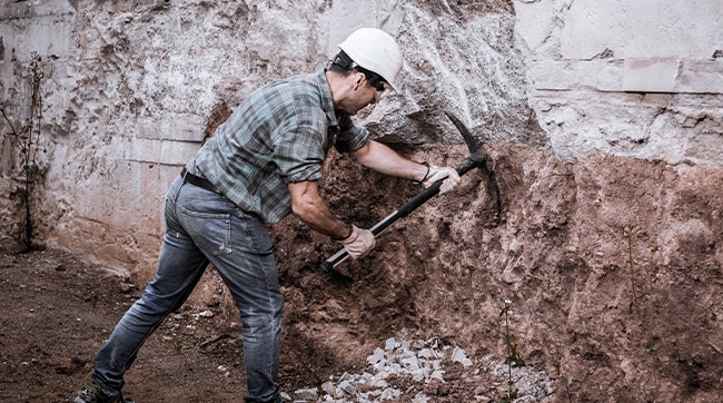 Man with pick axe representing the mining era in Kingswood, Gloucestershire