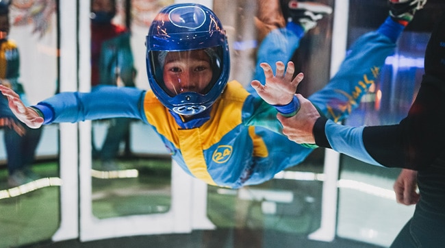 a young boy indoor skydiving