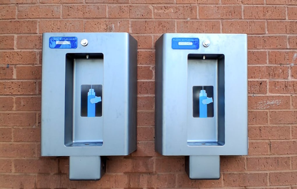 2 Font 50 wall mounted bottle dispenser installed to the outside of a school wall