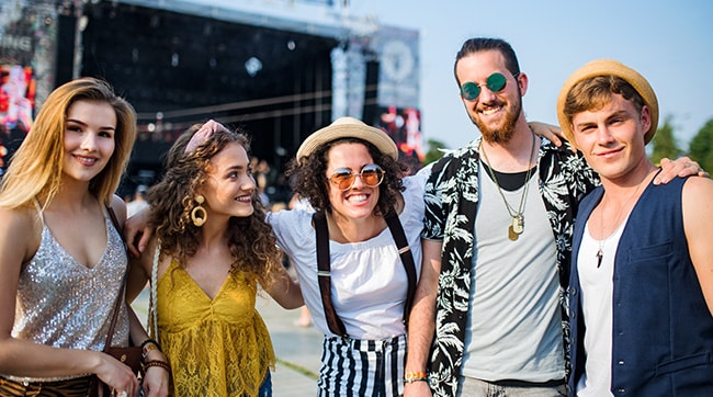 a group of festival goers in front of a stage
