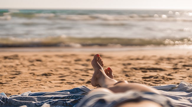 someone sunbathing on the beach